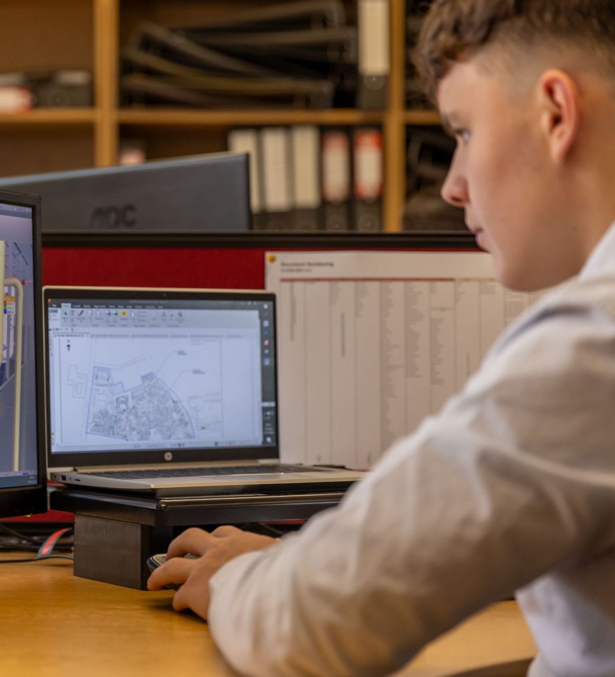 Engineer working on drawings at a workstation