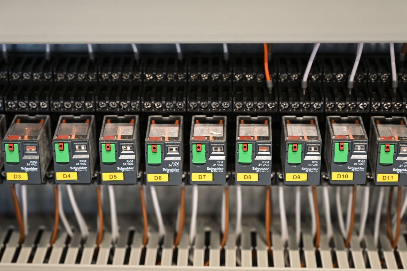 Relay and I/O modules on DIN rail in a control panel